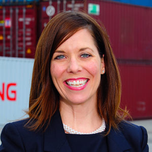 A professional headshot of Laura G. Blair, Vice President of Administration and External Affairs. Containers are in the background.